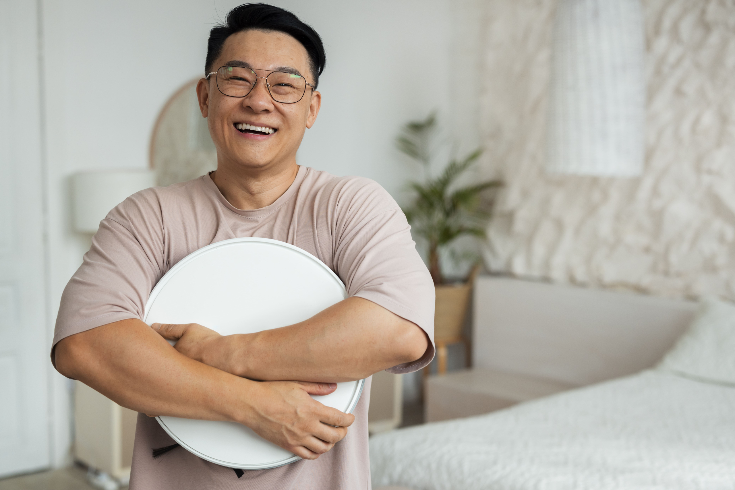 front-view-man-with-robotic-vacuum-cleaner-home
